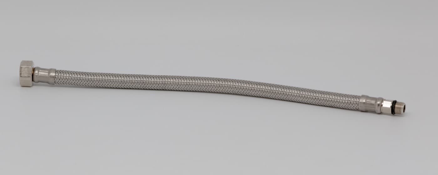 A new flexible plumbing hose with a brass fitting nut at one end.